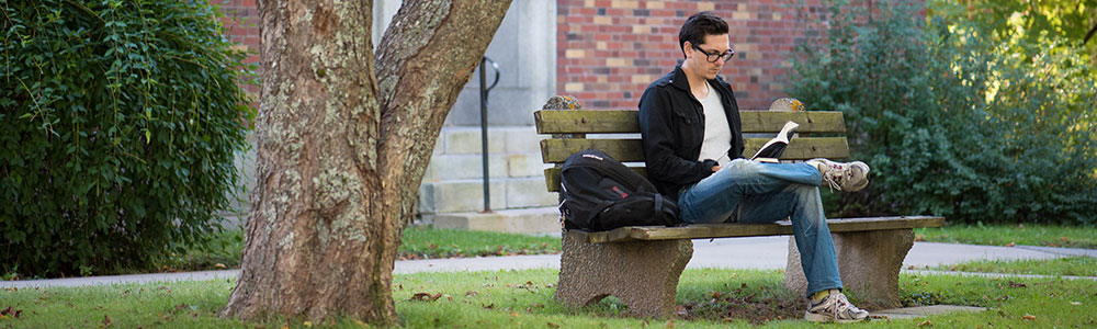 boy sitting under tree