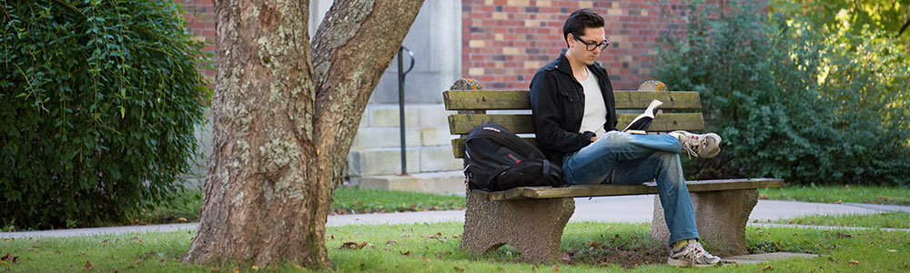 boy sitting under tree
